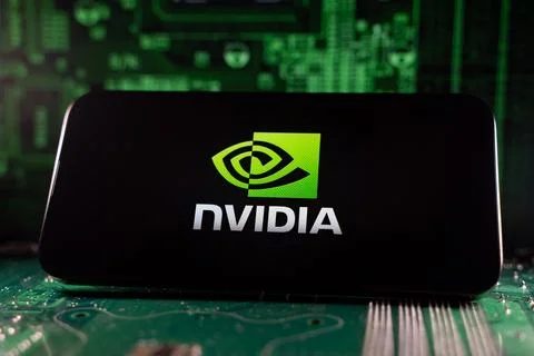 Close up of Nvidia logo on smartphone screen with motherboard background. Stock Photos