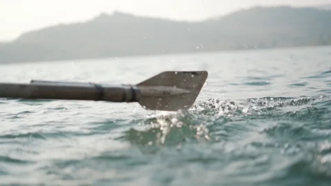 Close up of an oar rowing small boat in lake 스톡 동영상 234625791