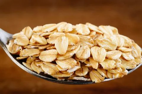Close up of oat flakes in spoon Stock Photos