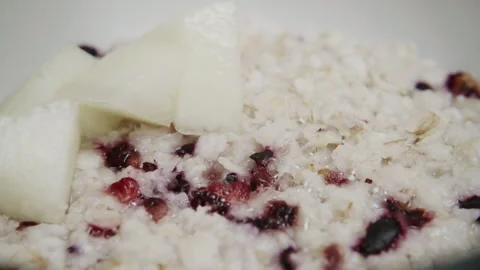 Close up of oatmeal with mixed berries and melon slices for a breakfast Stock Footage 340406648