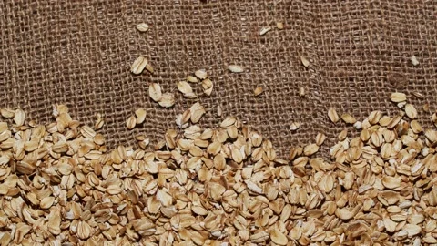 Close-up oatmeal texture, closeup oat flakes, vegetarian healthy food background Stockbeeldmateriaal 198302640