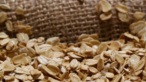 Close-up oatmeal texture, closeup oat flakes, vegetarian healthy food background 動画素材 203686735