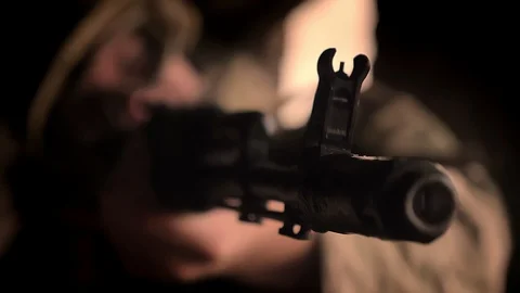 Close-up objective of automatic gun in the hands of caucasian soldier wearing Stock Footage 97721529