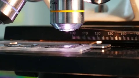 Close up on objective lens of microscope in laboratory. Stock Footage 79293662