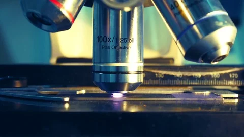 Close up on objective lens of microscope in laboratory. Stock Footage 79297457