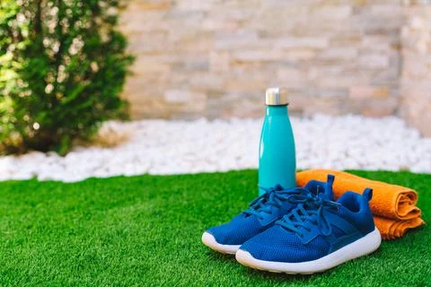 Close-up of objects and accessories to practise sports on green grass field Stock Photos