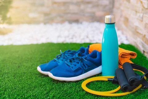 Close-up of objects and accessories for practising sport in a green grass garden Stock Photos