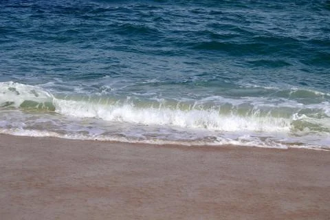 Close Up of the Ocean from a Sandy Beach Stock Photos