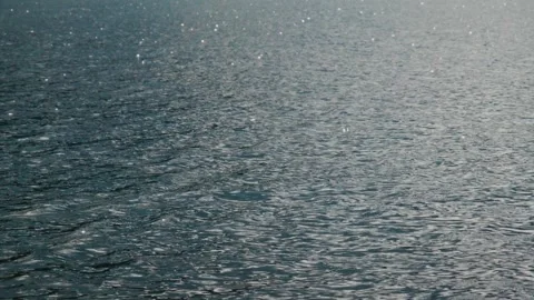 Close-up of ocean surface with sunlit ripples 스톡 동영상 335811914