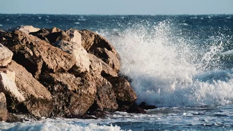 Close up of ocean waves breaking against large coastal rocks Stock Footage 325833010
