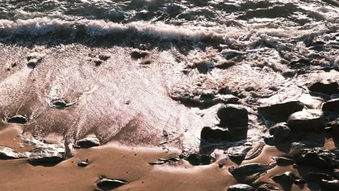 Close up ocean waves crashing on sandy and rocks beach in Portugal. Stock Footage 151122920