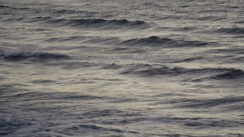Close up of ocean waves rolling on the beach at the sunset Stock Footage 92385806