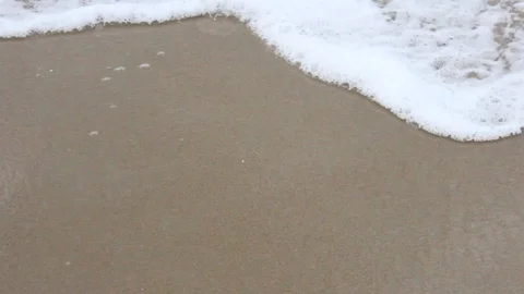 Close Up Ocean Waves Rush Across North Carolina Sand Video stock 106674129