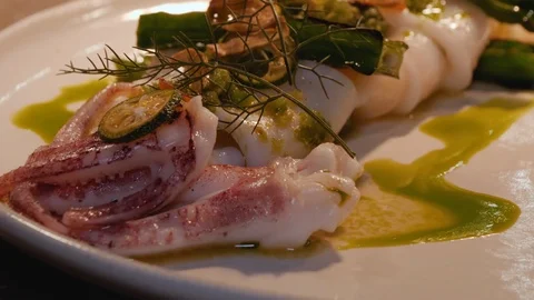 Close up of octopus with vegetables served on plate, local cuisine of Malaysia Stock Footage 146544376