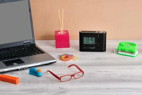 Close-up of office supplies with computer, on gray wooden table Stock Photos