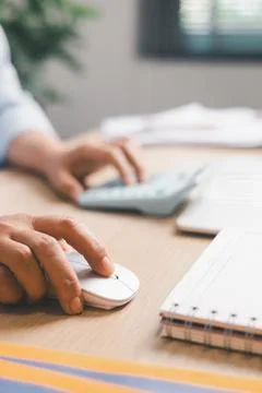 Close-up of office worker using computer mouse while working at desk, illus.. Foto stock