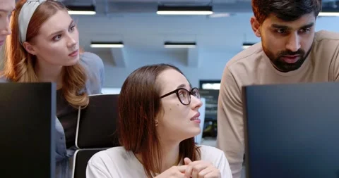 Close up of office workers talking at computer and watching at screen. Male and Stock Footage 180022536