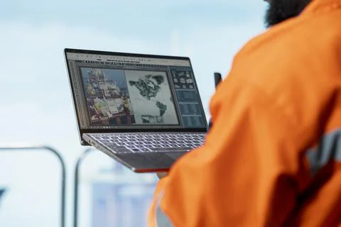 Close up of offshore engineer using laptop to conduct subsea mapping survey Stock Photos