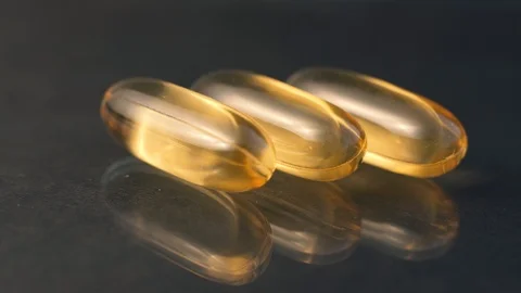 Close up of oil filled capsule soft gel suitable for presenting food supplements Stock Footage 101016339