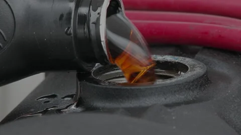 Close up of oil pouring into engine pan cover, 4K. Stock Footage 146183910