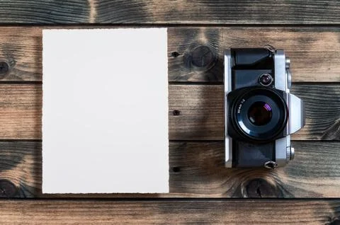 Close-up of an old 35mm camera on ancient wood background Stock Photos