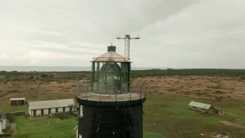 Close up of Old active Lighthouse , grey skies &amp; weather. keeper residence Stock Footage 142062973