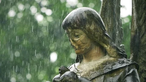Close-up of old angel monument face in Bernardine Cemetery during rain Stock Footage 336734088