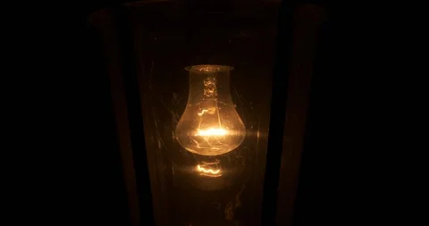 Close-up of an old black lantern swaying in the wind, it is dark outside, night Stock Footage 117063636
