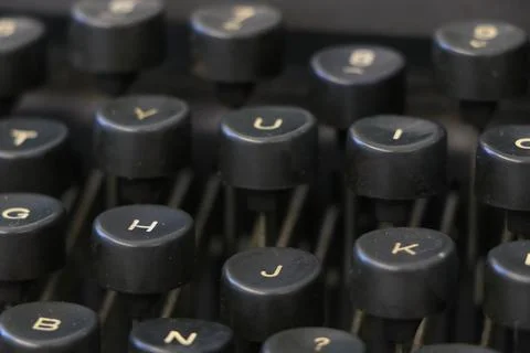 Close up of an old black typewriter keyboard with round keys Stock Photos