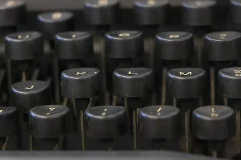 Close up of an old black typewriter keyboard with round keys Stock Photos