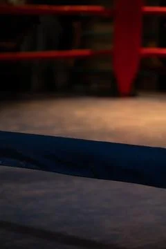 A close-up of an old boxing ring with ropes at a gym Stock Photos