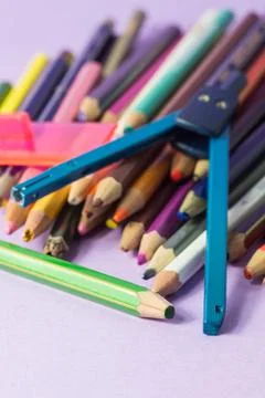 Close-up of old broken compass on old colored pens Stock Photos