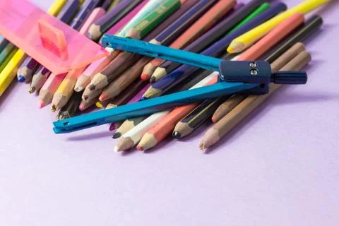 Close-up of old broken compass on old colored pens Stock Photos