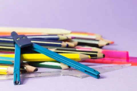 Close-up of old broken compass on old colored pens Stock Photos