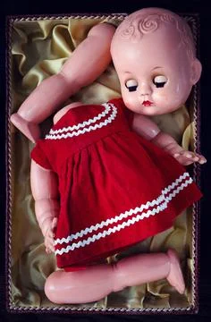 Close-up of an old broken doll in a box 스톡 사진