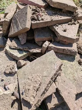 Close up of old broken pation pavement slabs dug up from house garden renov.. Stock Photos