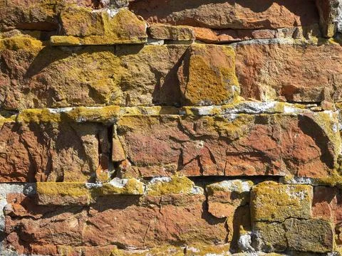 Close-up of an old broken red brick wall. Texture, pattern, vintage. Stock Photos