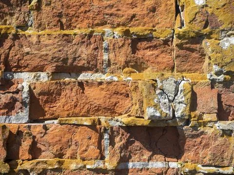 Close-up of an old broken red brick wall. Texture, pattern, vintage. Stock Photos