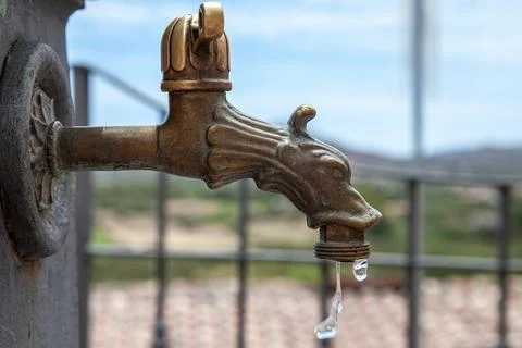 Close up of an old bronze dragon shaped tap fountain Stock-Fotos