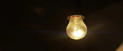 Close-up of old bulb lighted inside 5.7K scope video Stock Footage 304576030