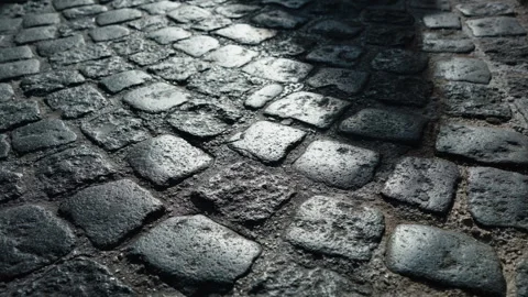Close up of old cobblestone pavement with shadows of passing people in Split Vídeo Stock 347348605