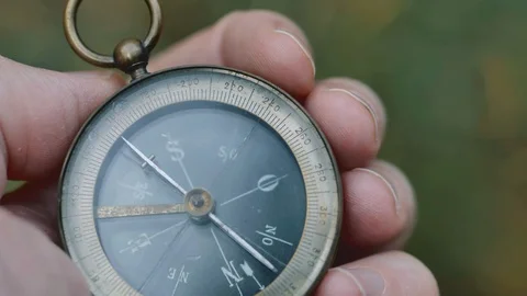 Close up on old compass instrument in hand. shot in slow motion Stock Footage 97459043