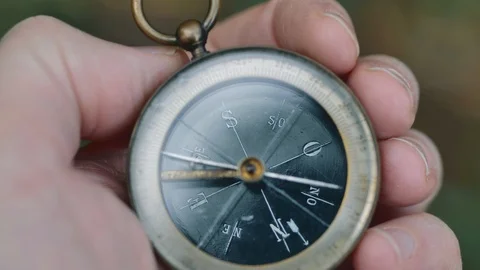 Close up on old compass instrument in hand. shot in slow motion Stock Footage 97493351