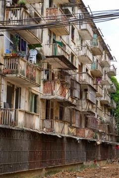 Close-up of old decrepit trees and wooden stakes in an old residential area Stock Photos