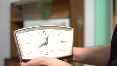 Close-up of an old Desk clock , hands spinning and time goes by . Wooden clock Stock Footage 98951598