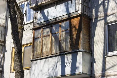 Close-up of an old dilapidated balcony lined with wood in an old soviet apa.. Stock Photos