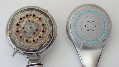 Close-up of old dirty shower head and new clean shower head Video stock 74830406