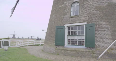 Close-up of an old dutch windmill with wings passing by Stock Footage 145145655