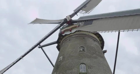 Close-up of an old dutch windmill with wings passing by Stock Footage 145150154
