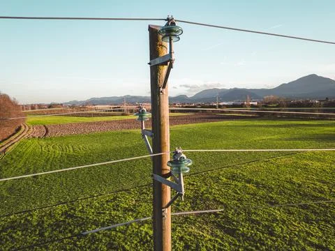 Close up of an old electrical tower with electrical wire running to and from it Stock Photos
